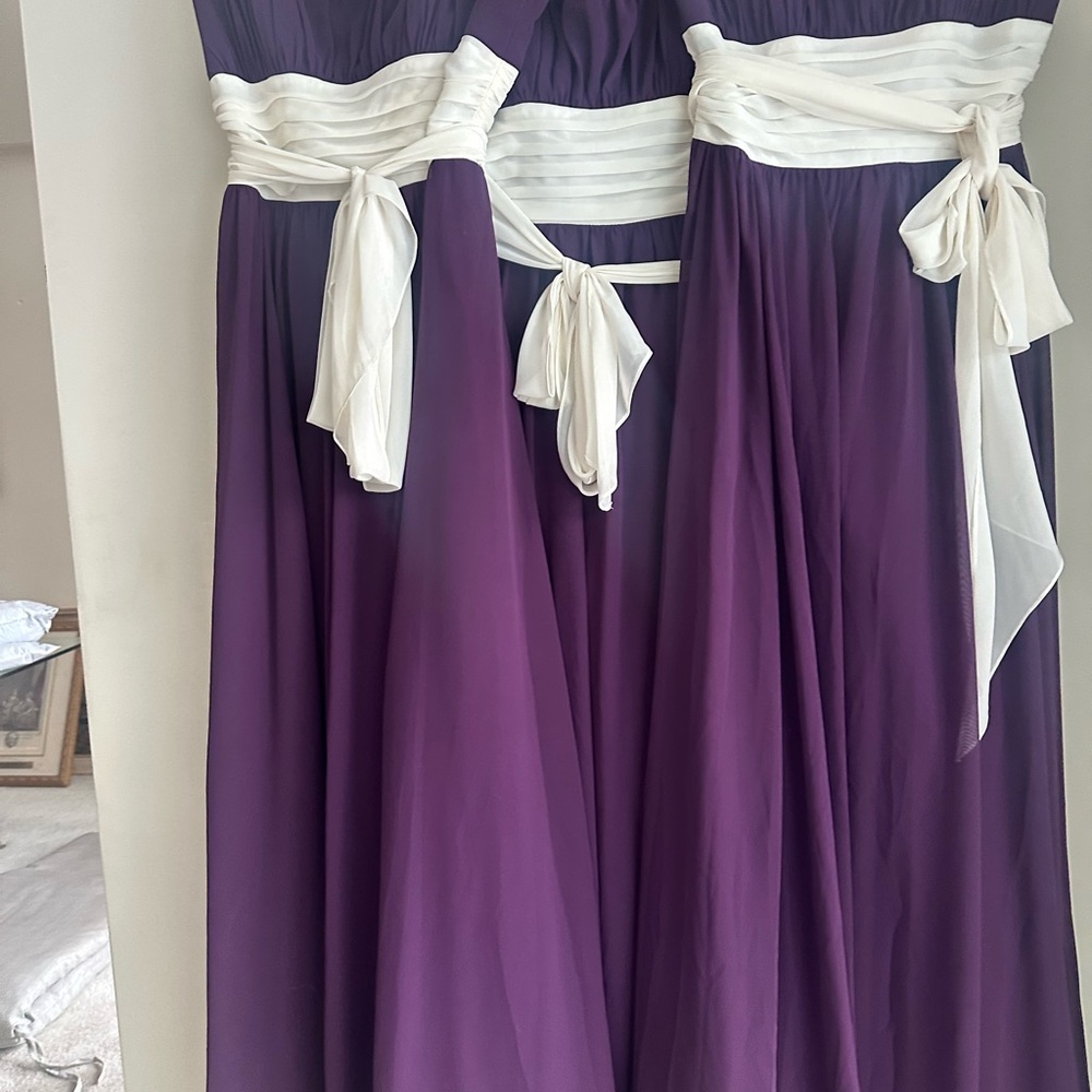 3 plum bridesmaid gowns. Ivory bodice ties. Wired strapless bodice.